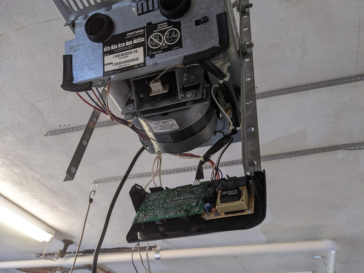 Garage door opener unit, still mounted on the ceiling with the case off